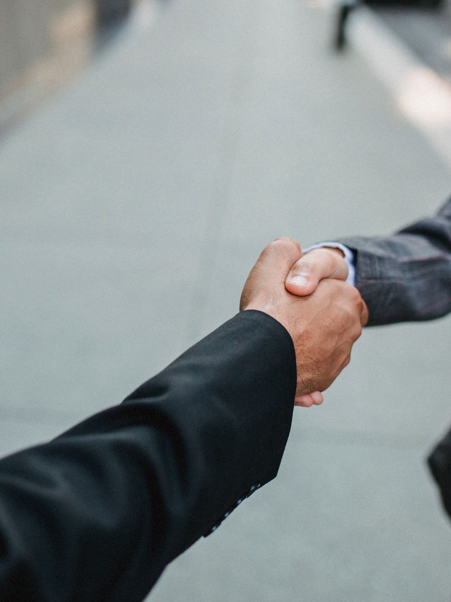 Two professionals shaking hands after a meeting